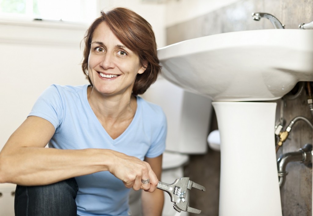 Woman fixing plumbing in a Noblesville, Indiana home