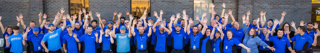 Group shot of employees waving